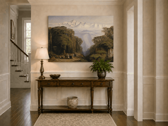 Hand-painted tropical jungle with snow-capped peaks and villagers landscape oil painting displayed above a console table in a hallway interior.