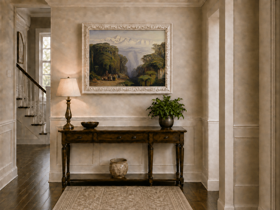 Hand-painted tropical jungle with snow-capped peaks and villagers landscape oil painting displayed above a console table in a hallway interior.