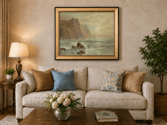 Framed hand-painted seascape oil painting with wave-washed rocks beneath soft-hued skies displayed above a neutral living room sofa.