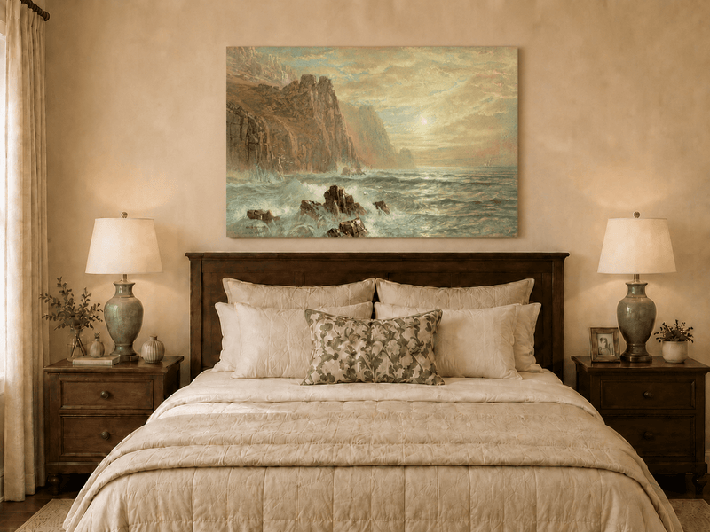 Unframed hand-painted seascape oil painting with wave-washed rocks beneath soft-hued skies displayed above a wooden bed in a neutral bedroom.
