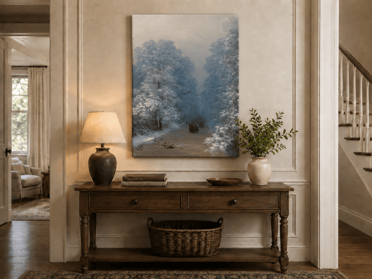 Hand-painted winter forest path landscape oil painting displayed above a console table in a hallway interior.