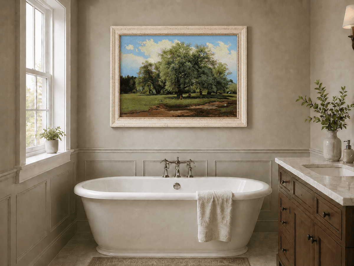 Framed hand-painted meadow oil painting with trees and small figures displayed above a freestanding bathtub.