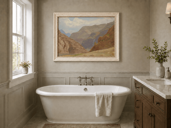 Framed hand-painted mountain canyon oil painting with a waterfall and grassy valley floor displayed above a freestanding bathtub.