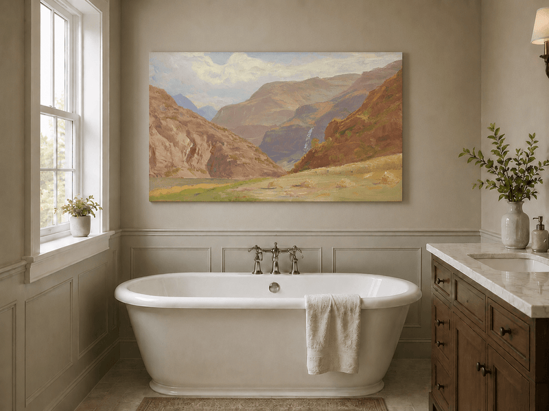 Unframed hand-painted mountain canyon oil painting with a waterfall and grassy valley floor displayed above a freestanding bathtub.