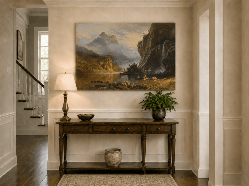 Unframed hand-painted mountain lake oil painting with Native American figures in a canoe above an entryway console table.