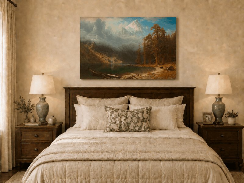 Unframed hand-painted mountain lake oil painting with redwood trees and a bear displayed above a wooden bed in a neutral bedroom.