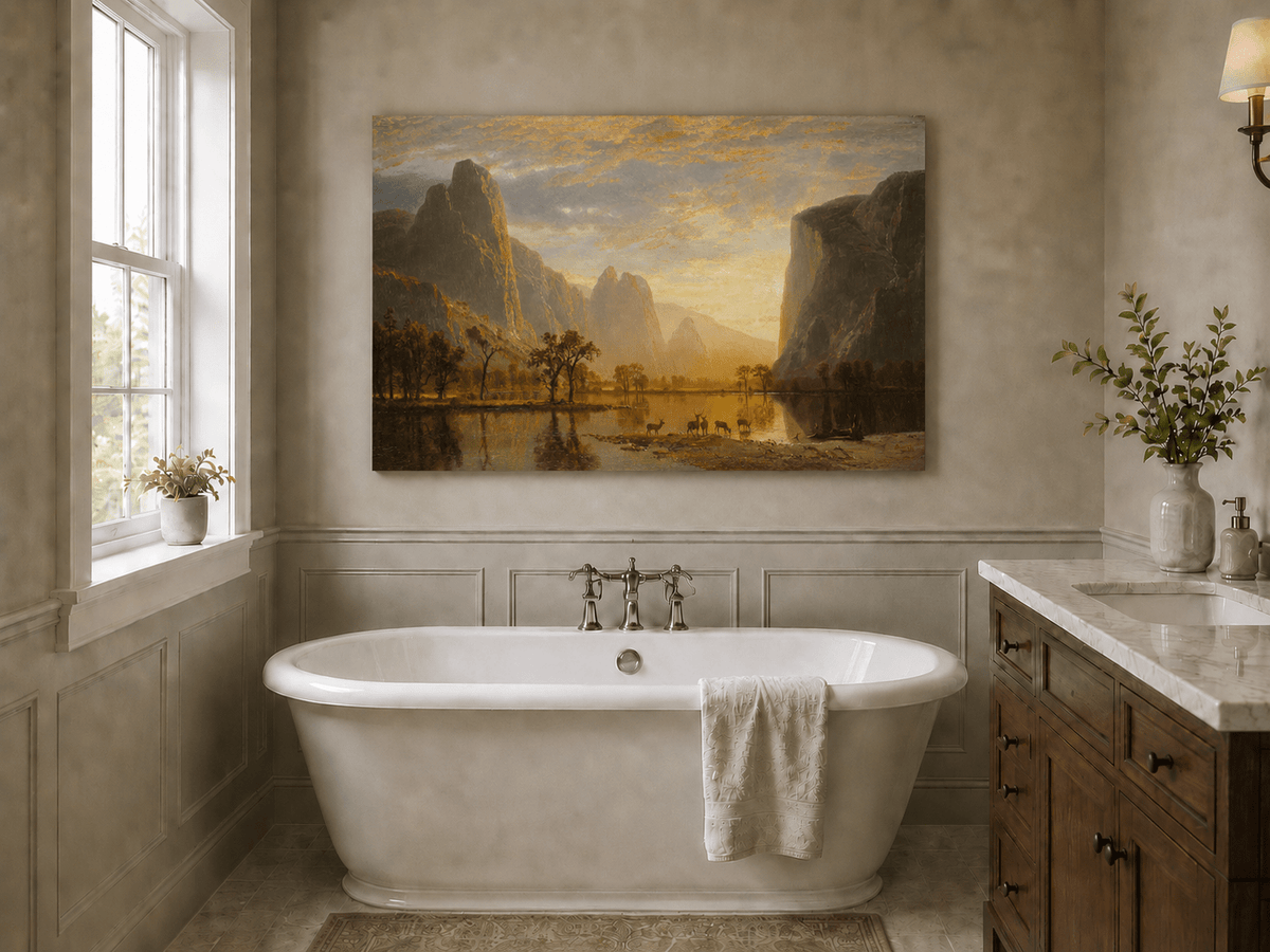 Unframed hand-painted mountain lake oil painting with deer beneath a golden sunset displayed above a freestanding bathtub.