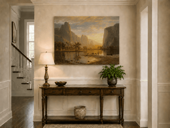Unframed hand-painted mountain lake oil painting with deer beneath a golden sunset displayed above an entryway console table.