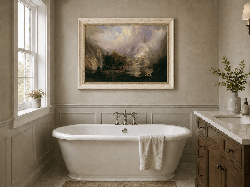 Framed hand-painted mountain lake oil painting with a waterfall and deer displayed above a freestanding bathtub.