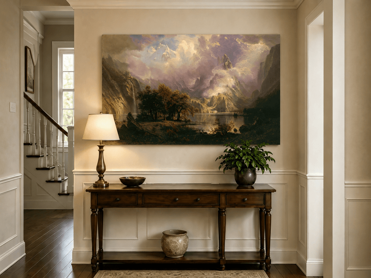 Unframed hand-painted mountain lake oil painting with a waterfall and deer displayed above an entryway console table.