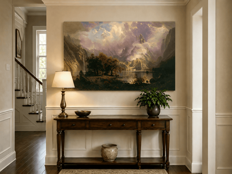 Unframed hand-painted mountain lake oil painting with a waterfall and deer displayed above an entryway console table.
