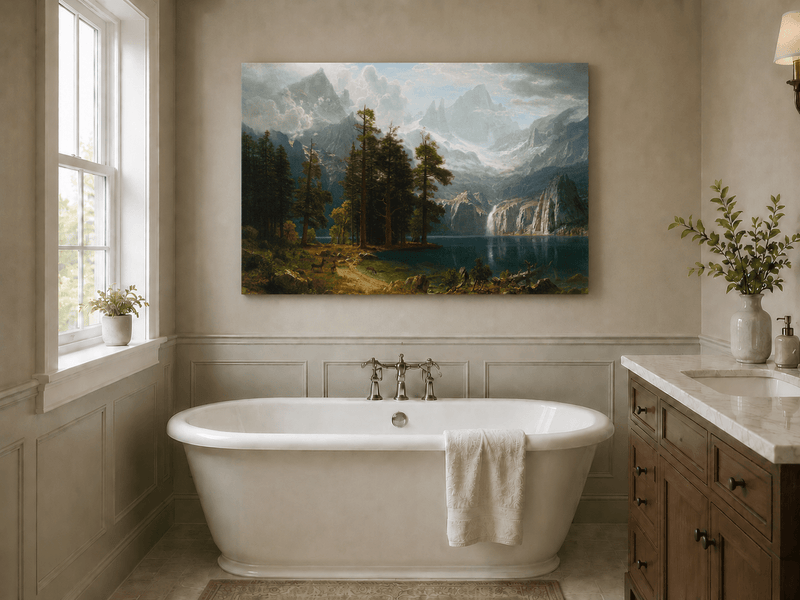 Unframed hand-painted mountain lake oil painting with pine forest, waterfall and misty peaks displayed above a freestanding bathtub.