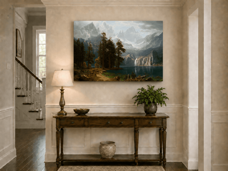 Unframed hand-painted mountain lake oil painting with pine forest, waterfall and misty peaks displayed above an entryway console table.