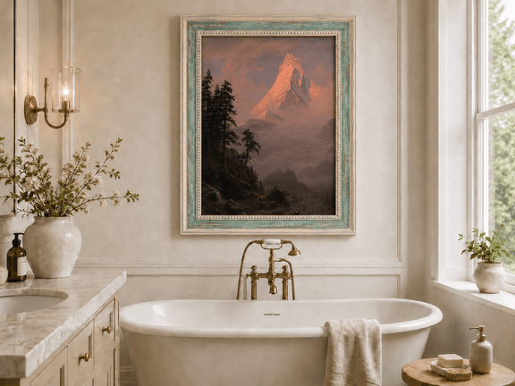 Framed hand-painted mountain oil painting with a sunlit peak, dark forest and mist displayed above a freestanding bathtub.