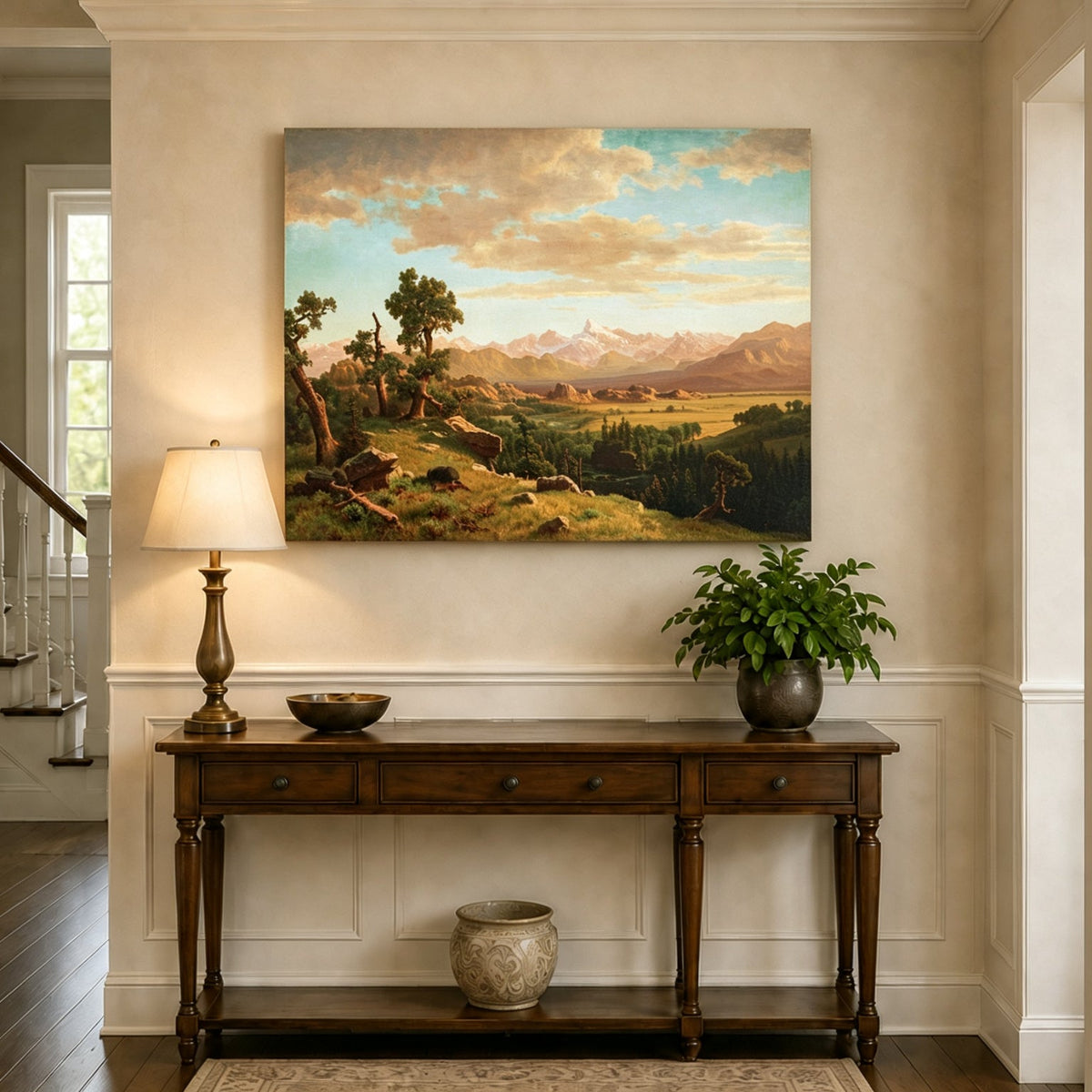 Unframed hand-painted mountain valley panorama with golden hills and distant peaks displayed above an entryway console table.