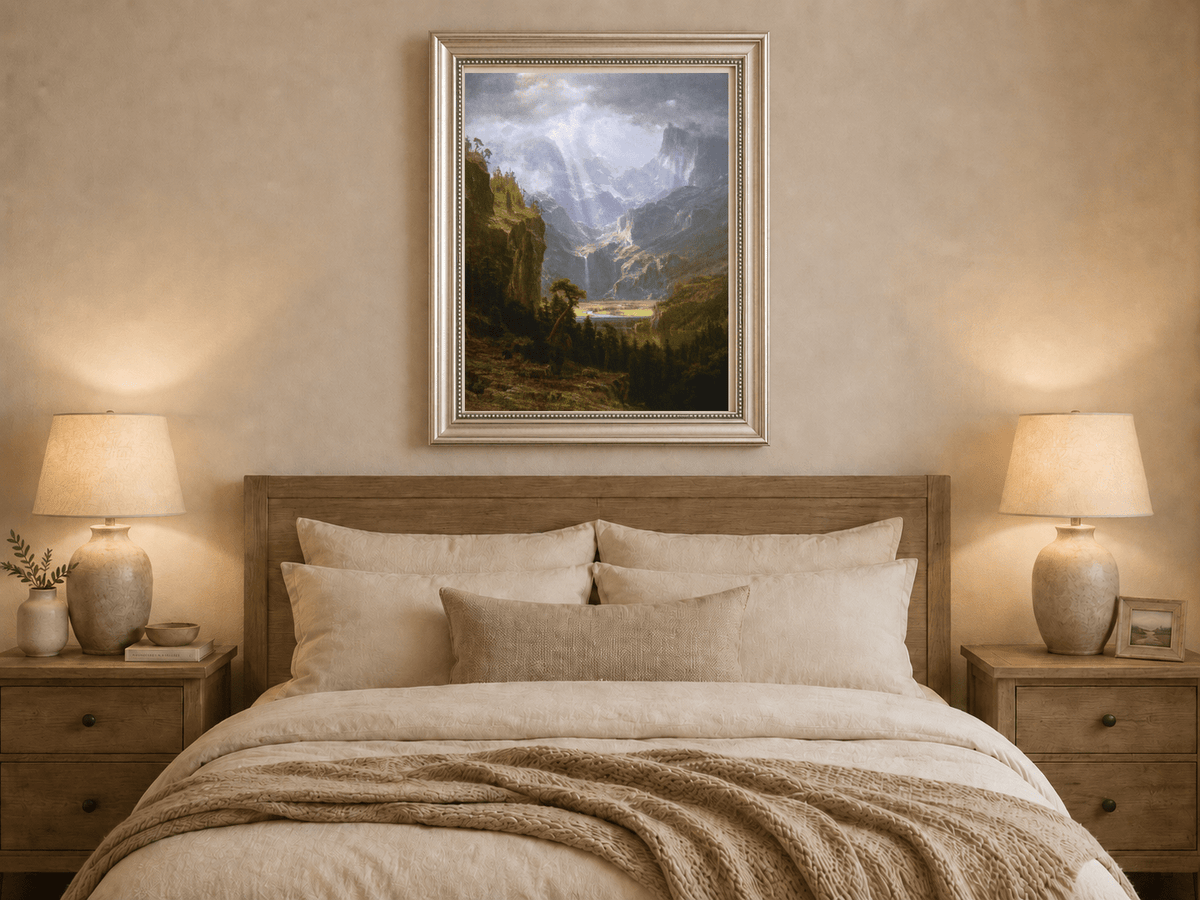 Framed hand-painted mountain valley oil painting with a waterfall and lake displayed above a wooden bed in a neutral bedroom.