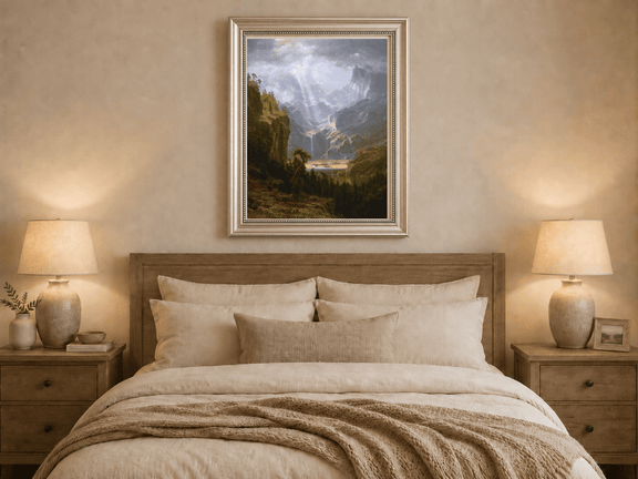 Framed hand-painted mountain valley oil painting with a waterfall and lake displayed above a wooden bed in a neutral bedroom.