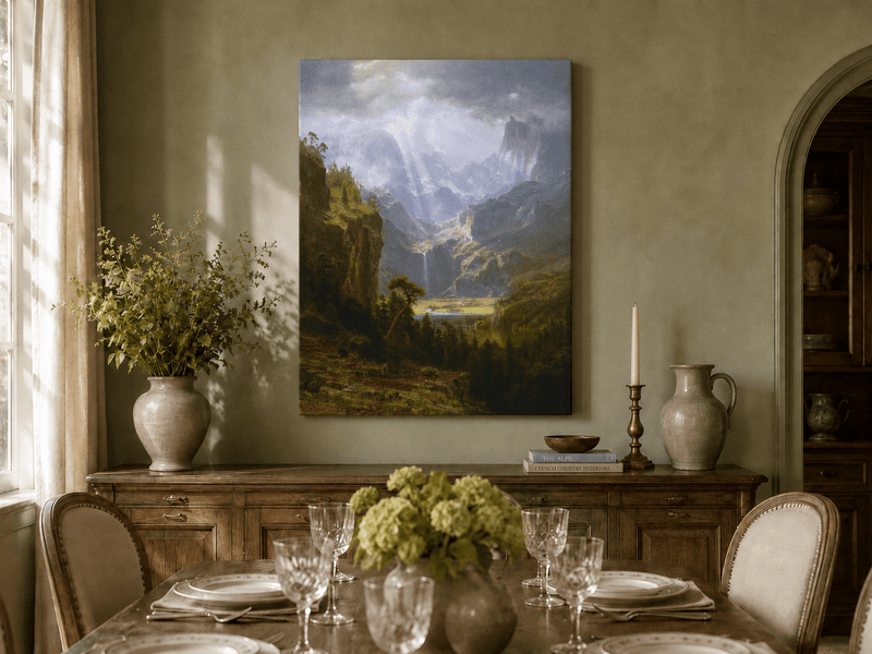 Unframed hand-painted mountain valley oil painting with a waterfall and lake displayed above a formal dining table.