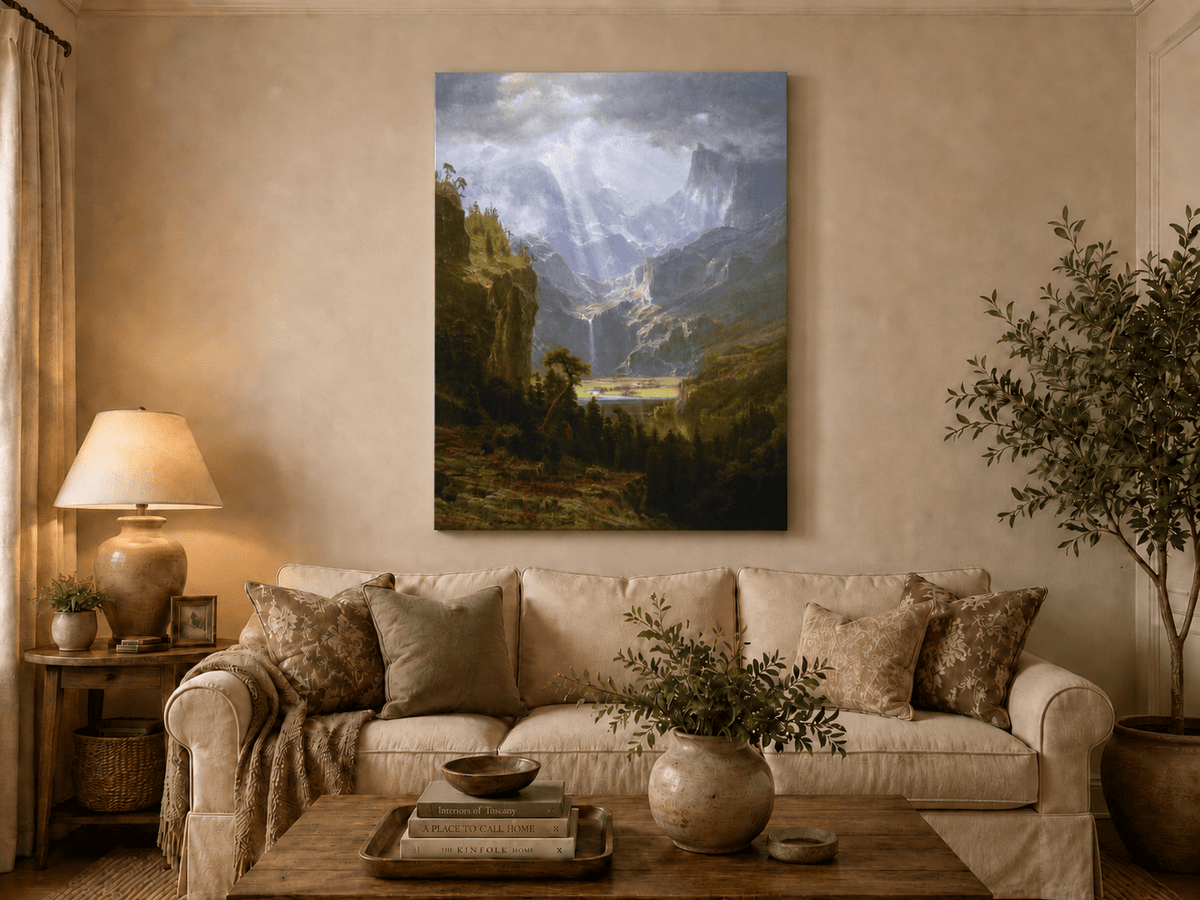 Unframed hand-painted mountain valley oil painting with a waterfall and lake displayed above a neutral living room sofa.