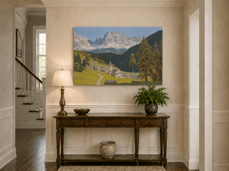 Unframed hand-painted alpine landscape oil painting with a mountain village, church and path displayed above an entryway console table.