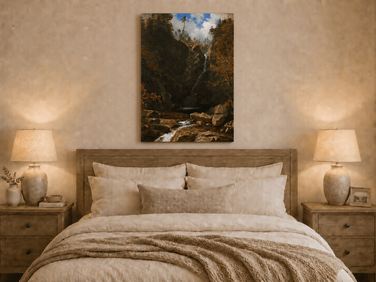 Unframed hand-painted mountain waterfall oil painting through a dark autumn forest displayed above a wooden bed in a neutral bedroom.