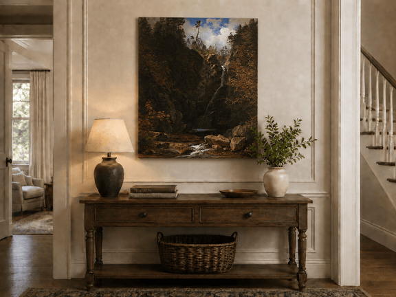 Unframed hand-painted mountain waterfall oil painting through a dark autumn forest displayed above an entryway console table.