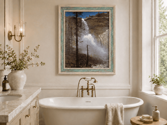 Framed hand-painted mountain waterfall oil painting with rocky cliffs and pine forest displayed above a freestanding bathtub.