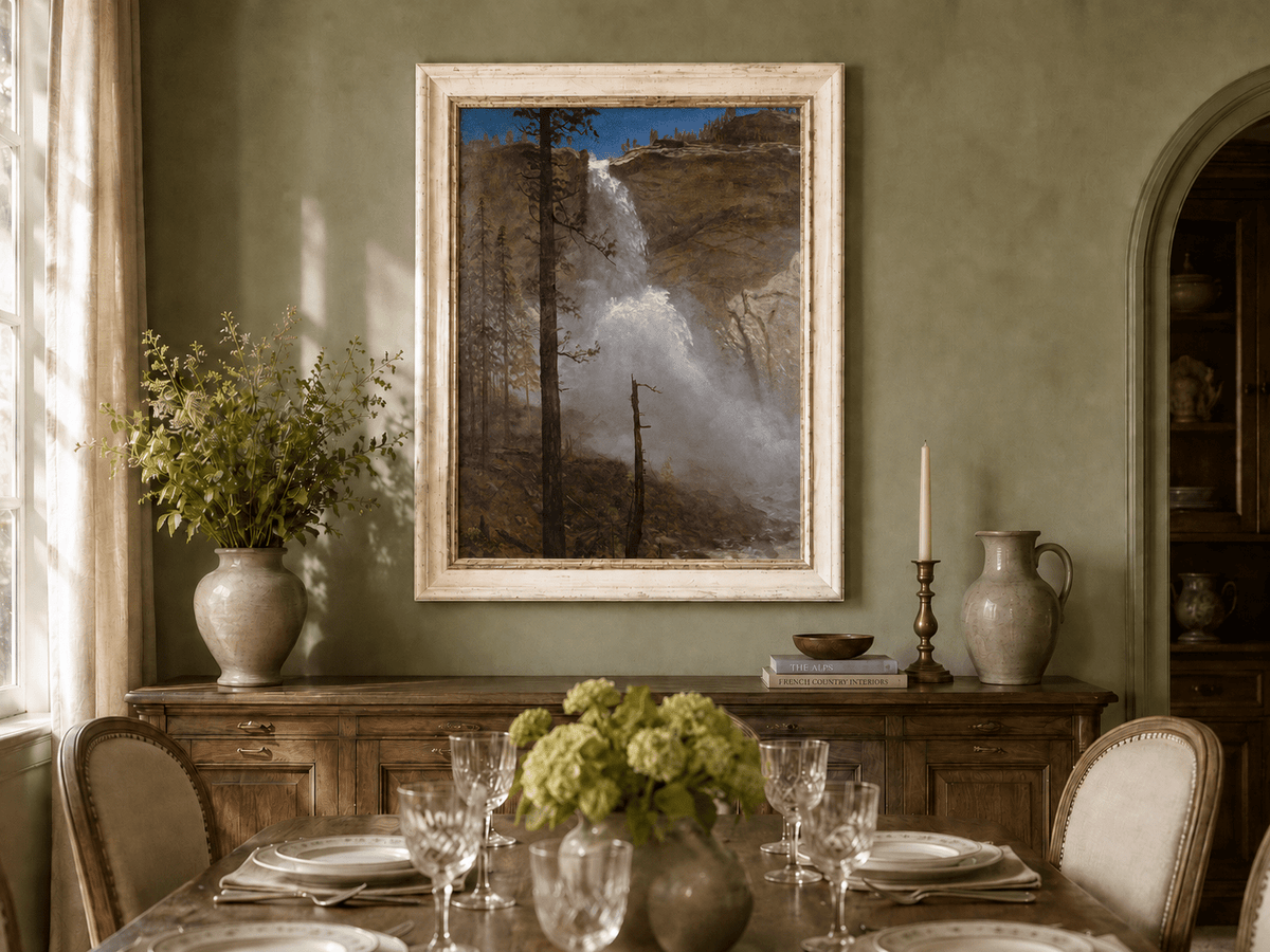 Framed hand-painted mountain waterfall oil painting with rocky cliffs and pine forest displayed above a formal dining table.