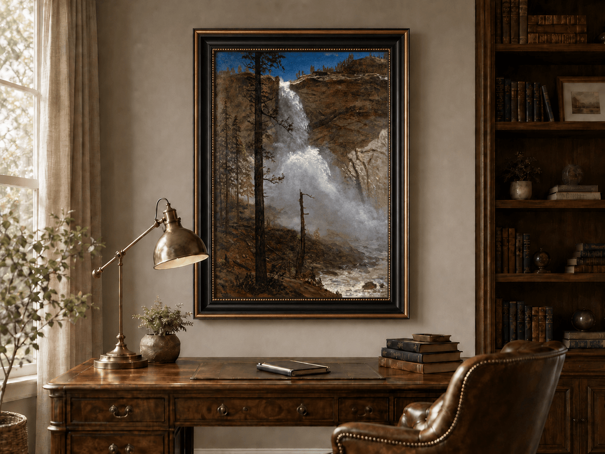 Framed hand-painted mountain waterfall oil painting with rocky cliffs and pine forest displayed above a traditional home office desk.