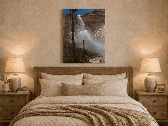 Unframed hand-painted mountain waterfall oil painting with rocky cliffs and pine forest displayed above a wooden bed in a neutral bedroom.