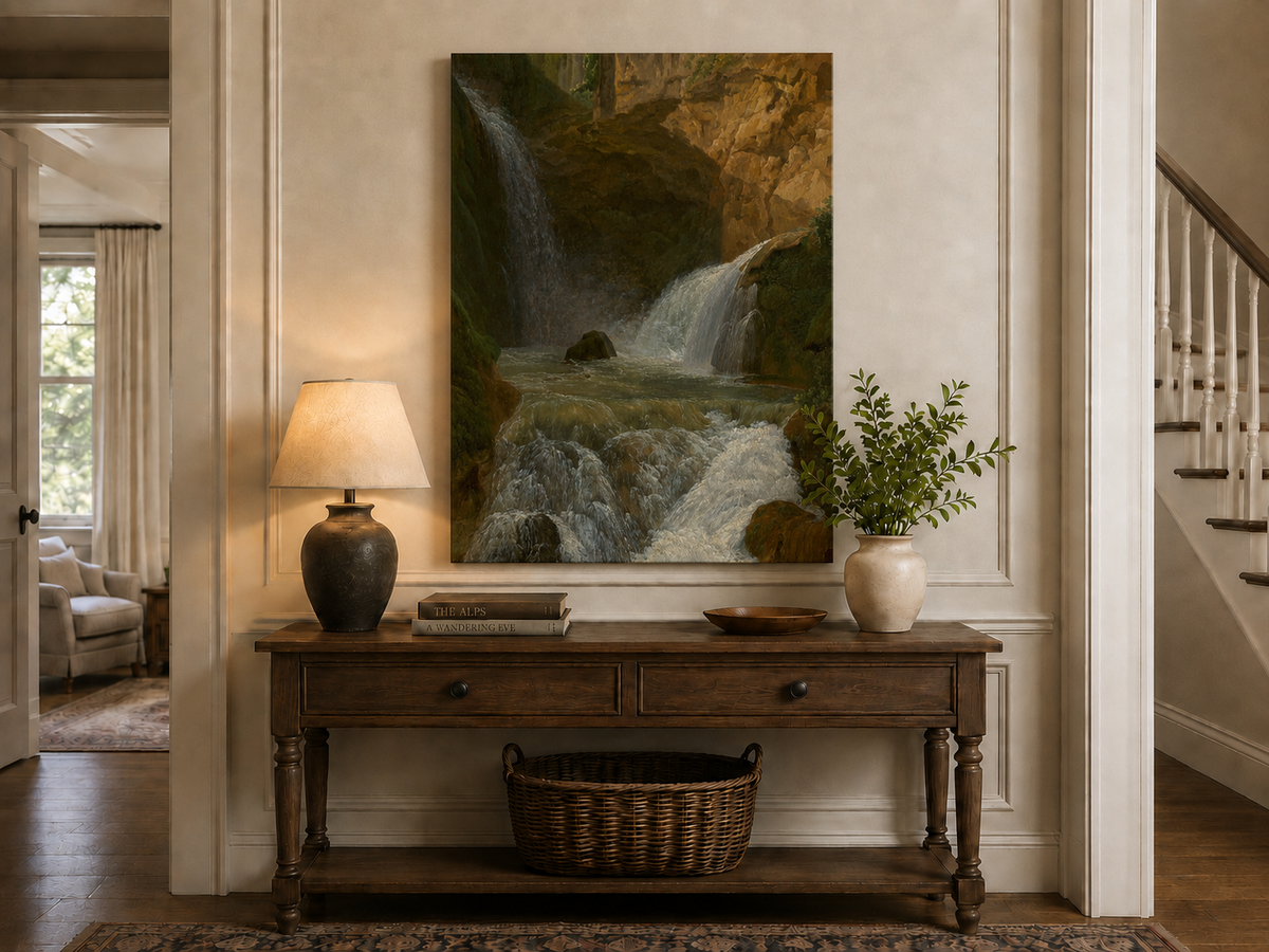 Hand-painted mountain waterfall in a rocky gorge landscape oil painting displayed above a console table in a hallway interior.
