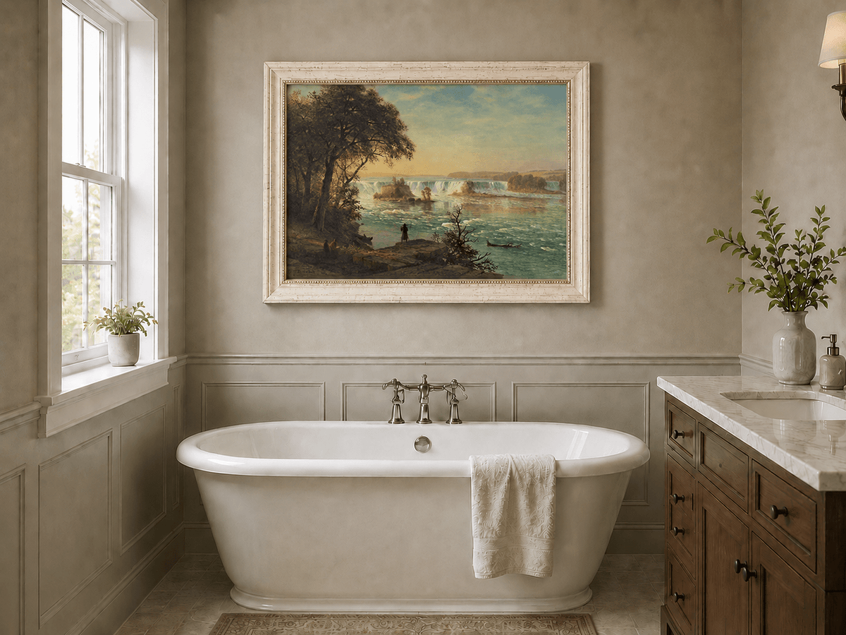 Framed hand-painted Niagara Falls oil painting with figures near the riverbank displayed above a freestanding bathtub.