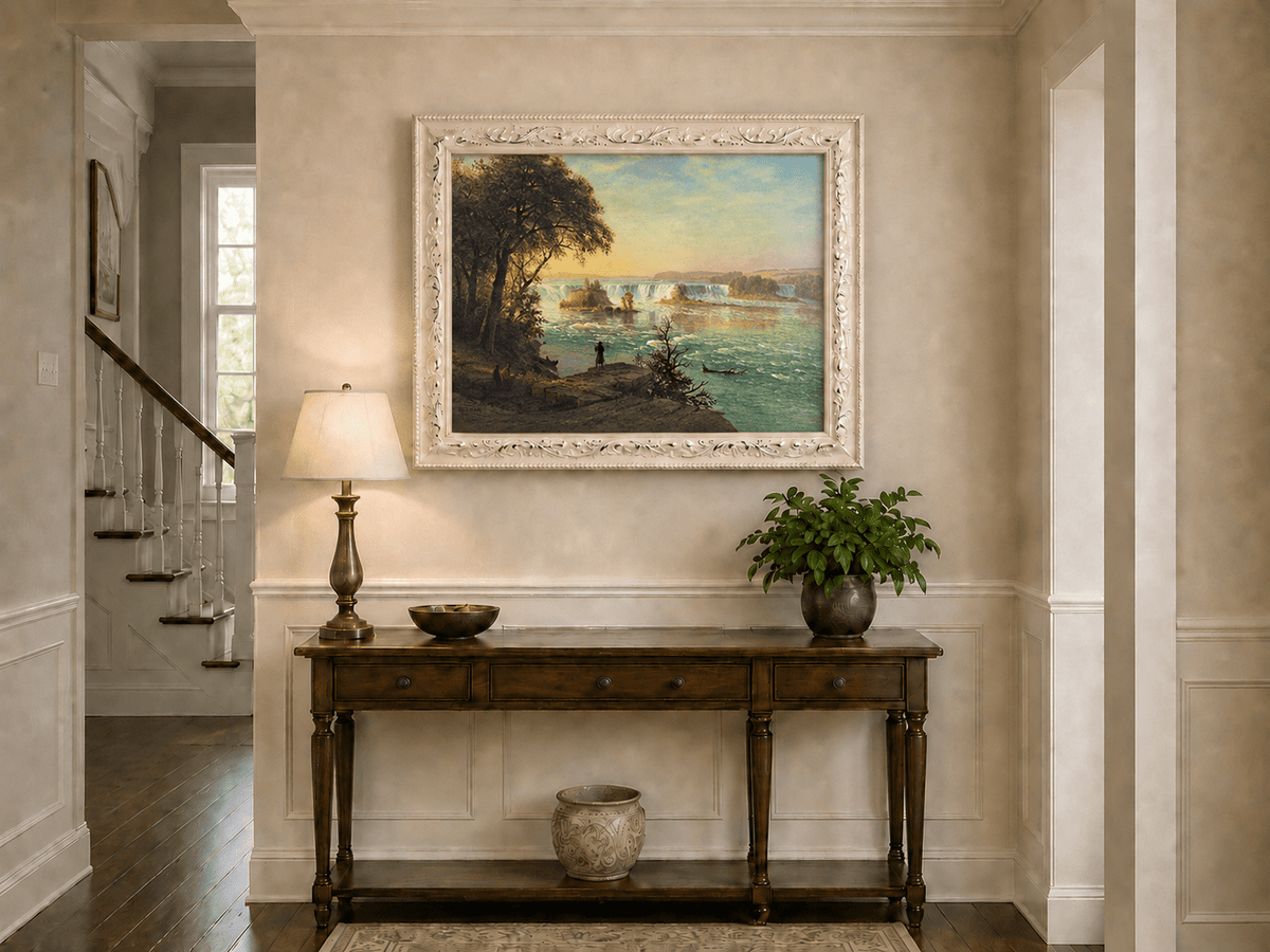 Framed hand-painted Niagara Falls oil painting with figures near the riverbank displayed above an entryway console table.