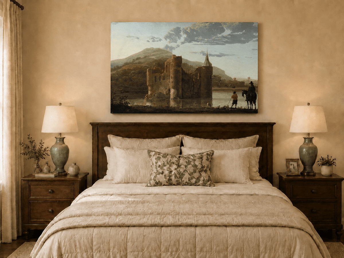 Unframed hand-painted castle ruins oil painting beside a lake with figures at sunset displayed above a wooden bed in a neutral bedroom.
