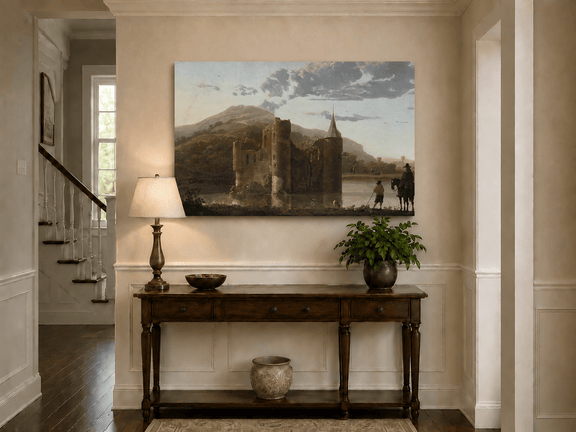 Unframed hand-painted castle ruins oil painting beside a lake with figures at sunset displayed above an entryway console table.