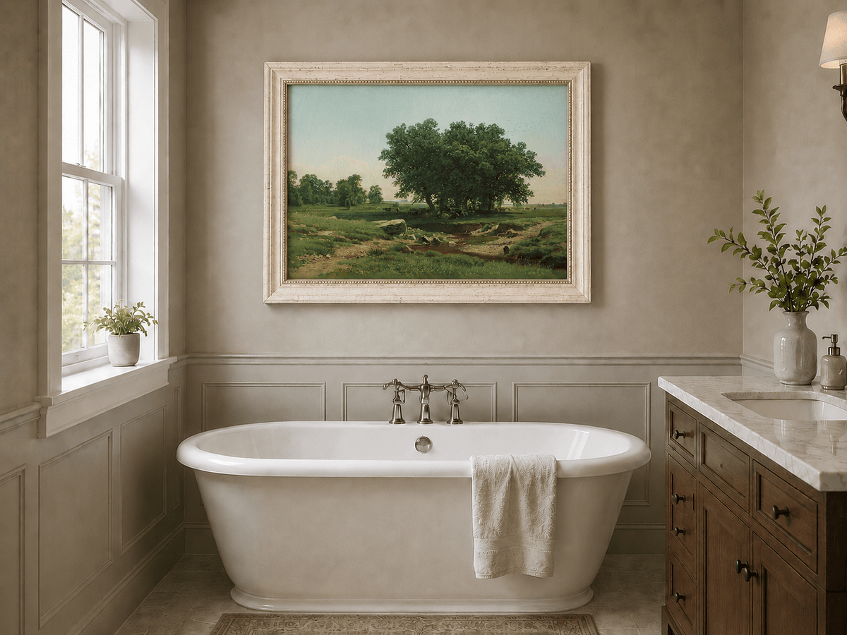 Framed hand-painted pastoral landscape oil painting with broad trees and a winding stream displayed above a freestanding bathtub.