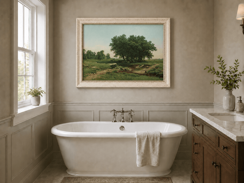 Framed hand-painted pastoral landscape oil painting with broad trees and a winding stream displayed above a freestanding bathtub.