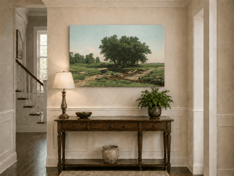 Unframed hand-painted pastoral landscape oil painting with broad trees and a winding stream displayed above an entryway console table.