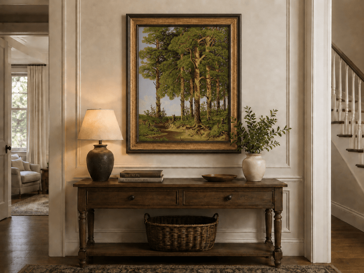 Framed hand-painted pine forest oil painting with a quiet stream displayed above an entryway console table.
