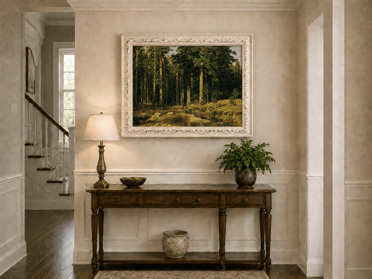 Framed hand-painted pine forest oil painting with a stream and rustic wooden bridge displayed above an entryway console table.