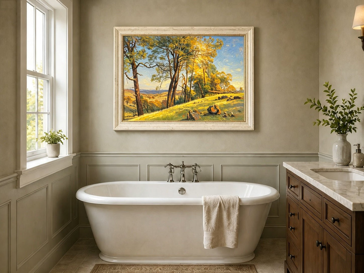 Framed hand-painted pine tree landscape oil painting on a bright sunlit hill displayed above a freestanding bathtub.