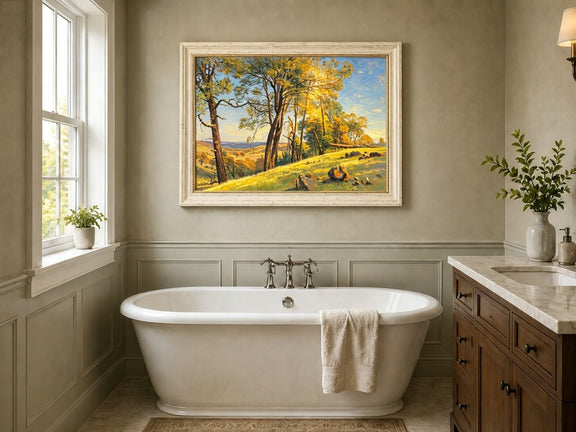 Framed hand-painted pine tree landscape oil painting on a bright sunlit hill displayed above a freestanding bathtub.