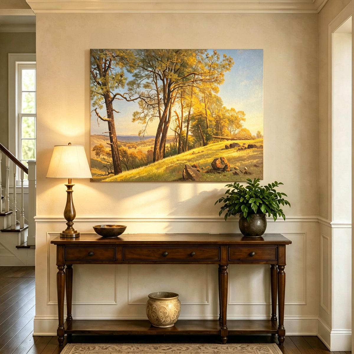 Unframed hand-painted pine tree landscape oil painting on a bright sunlit hill displayed above an entryway console table.