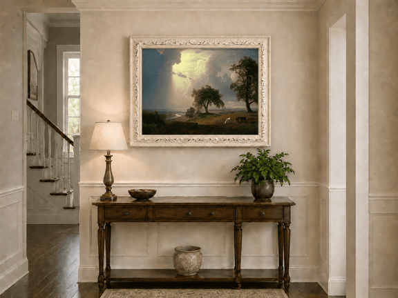 Framed hand-painted prairie oil painting with cattle beneath dramatic sunbeams displayed above an entryway console table.