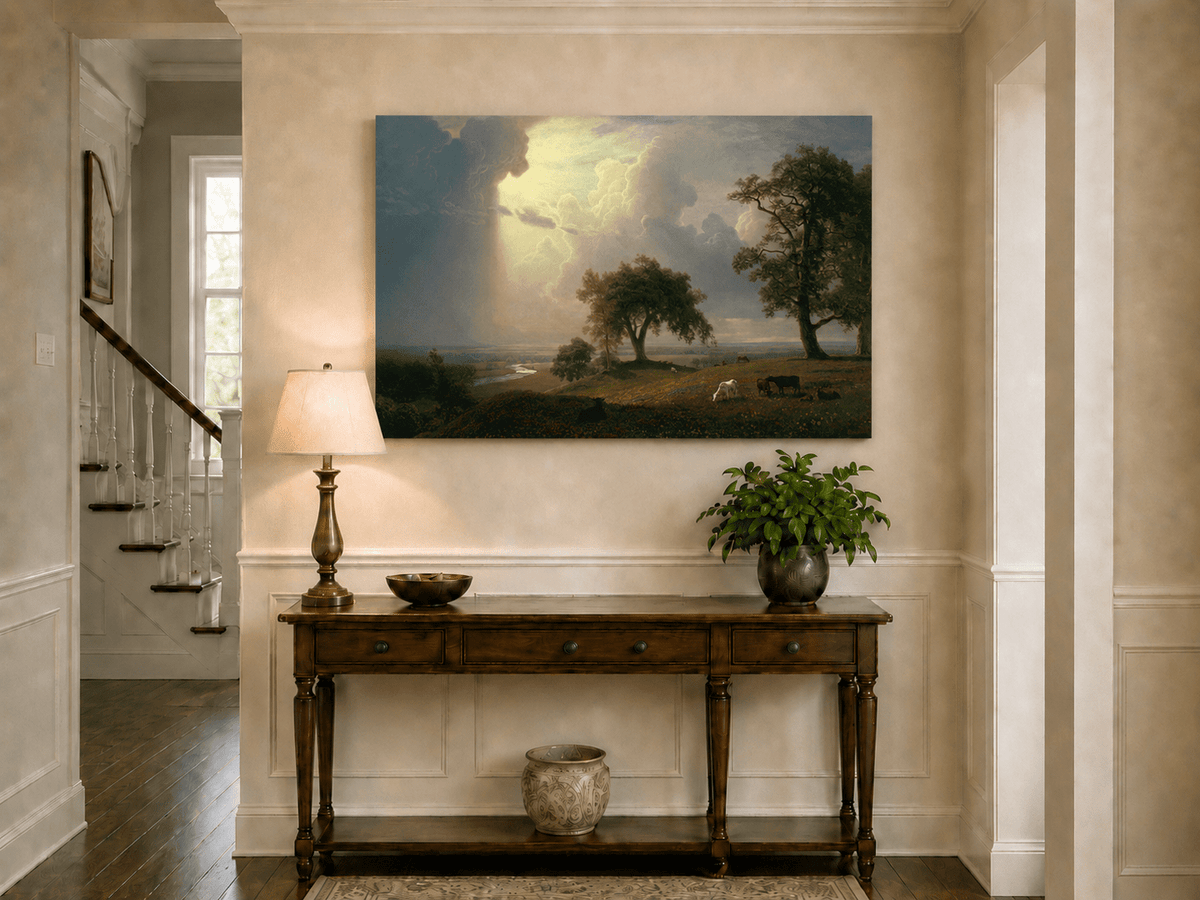 Unframed hand-painted prairie oil painting with cattle beneath dramatic sunbeams displayed above an entryway console table.
