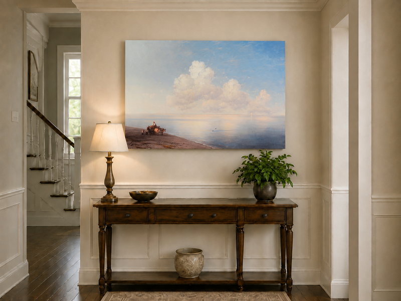 Hand-painted quiet seaside shore with ox cart landscape oil painting displayed above a console table in a hallway interior.
