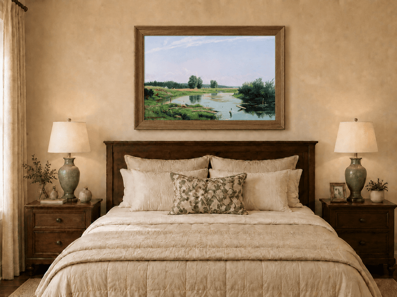 Framed hand-painted countryside oil painting with a winding river, green fields and trees displayed above a wooden bed in a neutral bedroom.