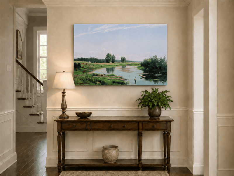 Unframed hand-painted countryside oil painting with a winding river, green fields and trees displayed above an entryway console table.