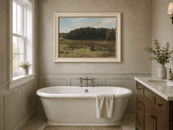 Framed hand-painted river landscape oil painting with wetlands and a dark forest edge displayed above a freestanding bathtub.