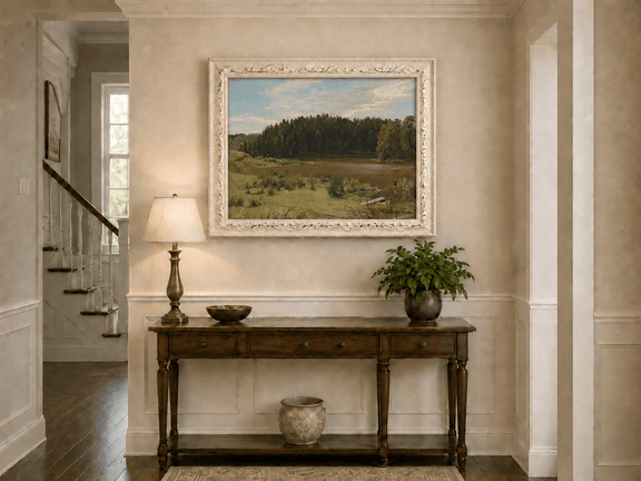 Framed hand-painted river landscape oil painting with wetlands and a dark forest edge displayed above an entryway console table.